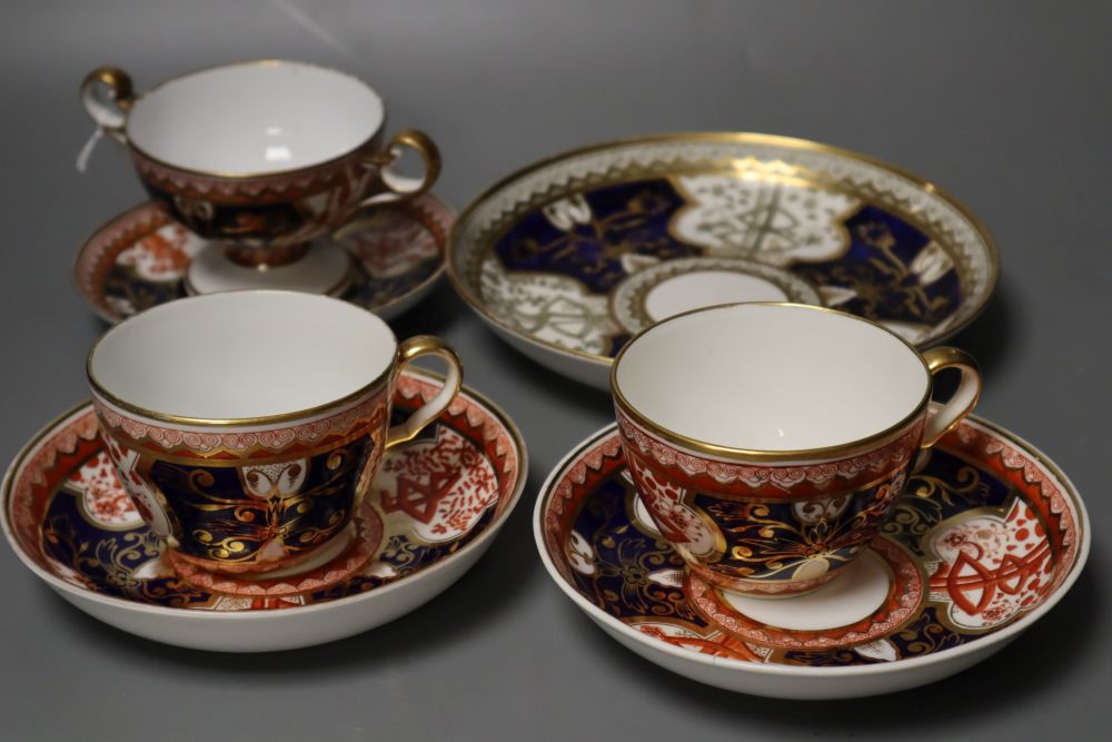 A Spode Dollar pattern two handled cup and saucer, two teacups and saucer and a saucer dish in a different version of the Dollar patter